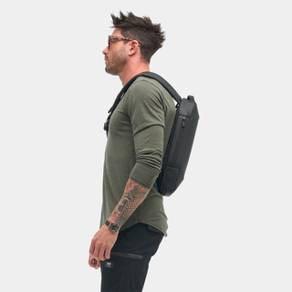 NOMATIC Navigator RS Sling 10L in black, worn cross-body by model, side view